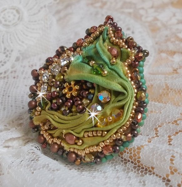 Venetian moon ring embroidered with a chameleon colored silk ribbon, Swarovski crystals, various pearls and seed beads