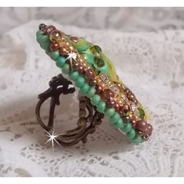 Venetian moon ring embroidered with a chameleon colored silk ribbon, Swarovski crystals, various pearls and seed beads