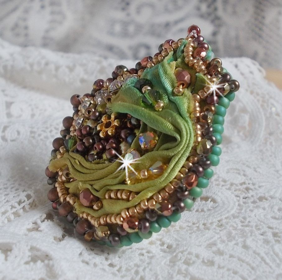 Venetian moon ring embroidered with a chameleon colored silk ribbon, Swarovski crystals, various pearls and seed beads