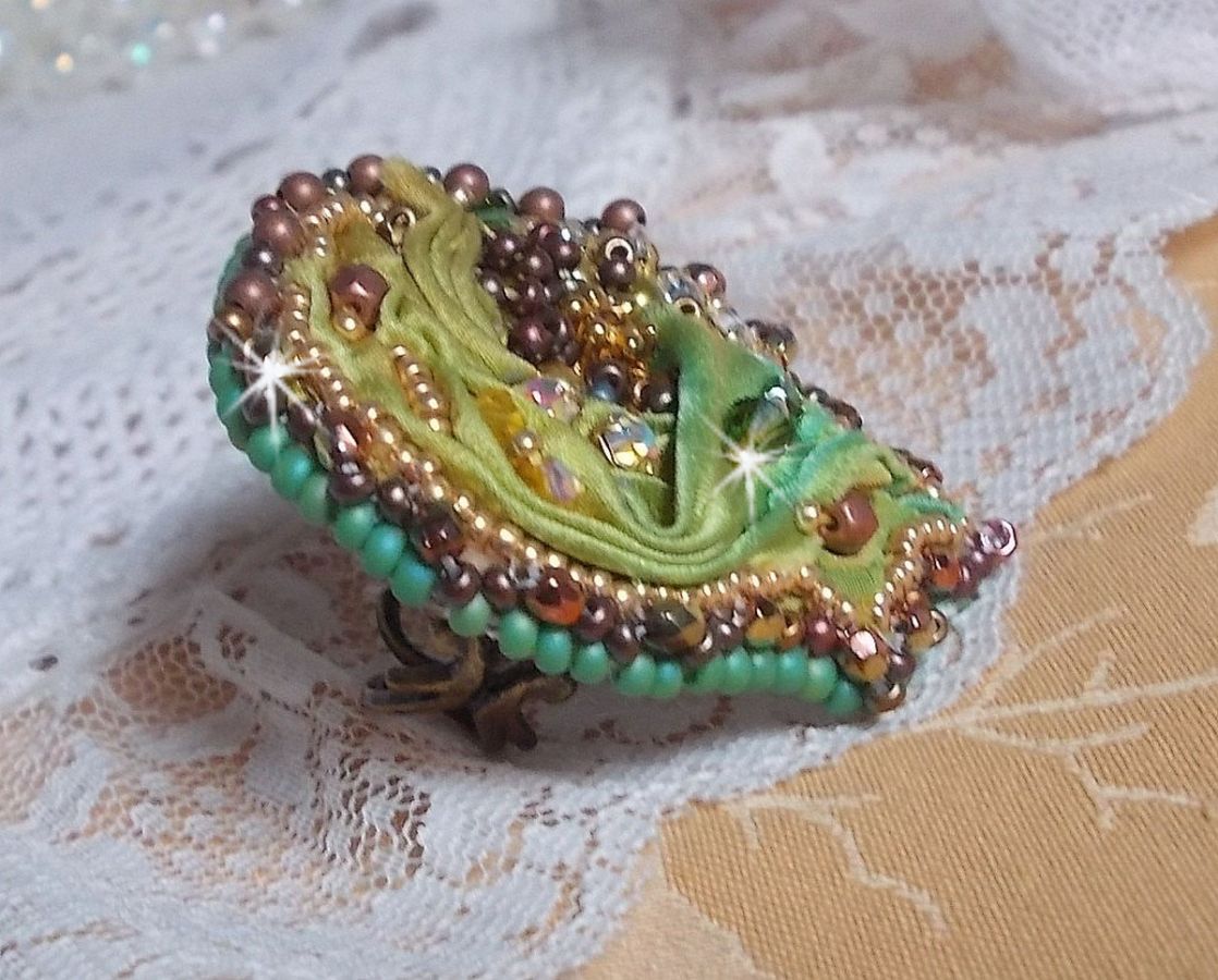 Venetian moon ring embroidered with a chameleon colored silk ribbon, Swarovski crystals, various pearls and seed beads