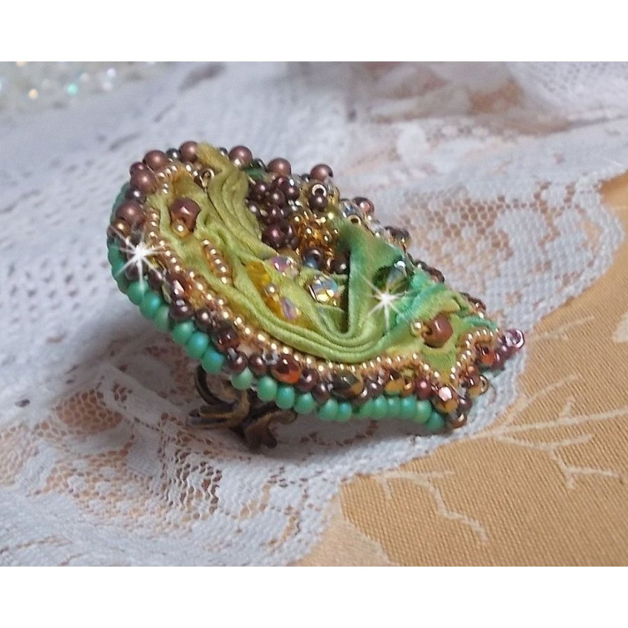 Venetian moon ring embroidered with a chameleon colored silk ribbon, Swarovski crystals, various pearls and seed beads