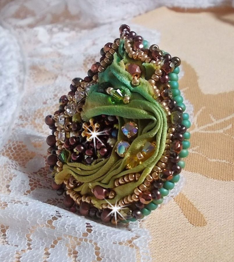 Venetian moon ring embroidered with a chameleon colored silk ribbon, Swarovski crystals, various pearls and seed beads