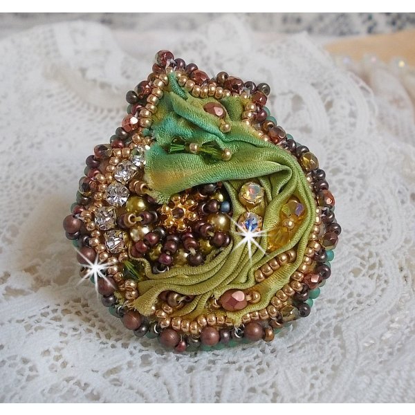 Venetian moon ring embroidered with a chameleon colored silk ribbon, Swarovski crystals, various pearls and seed beads