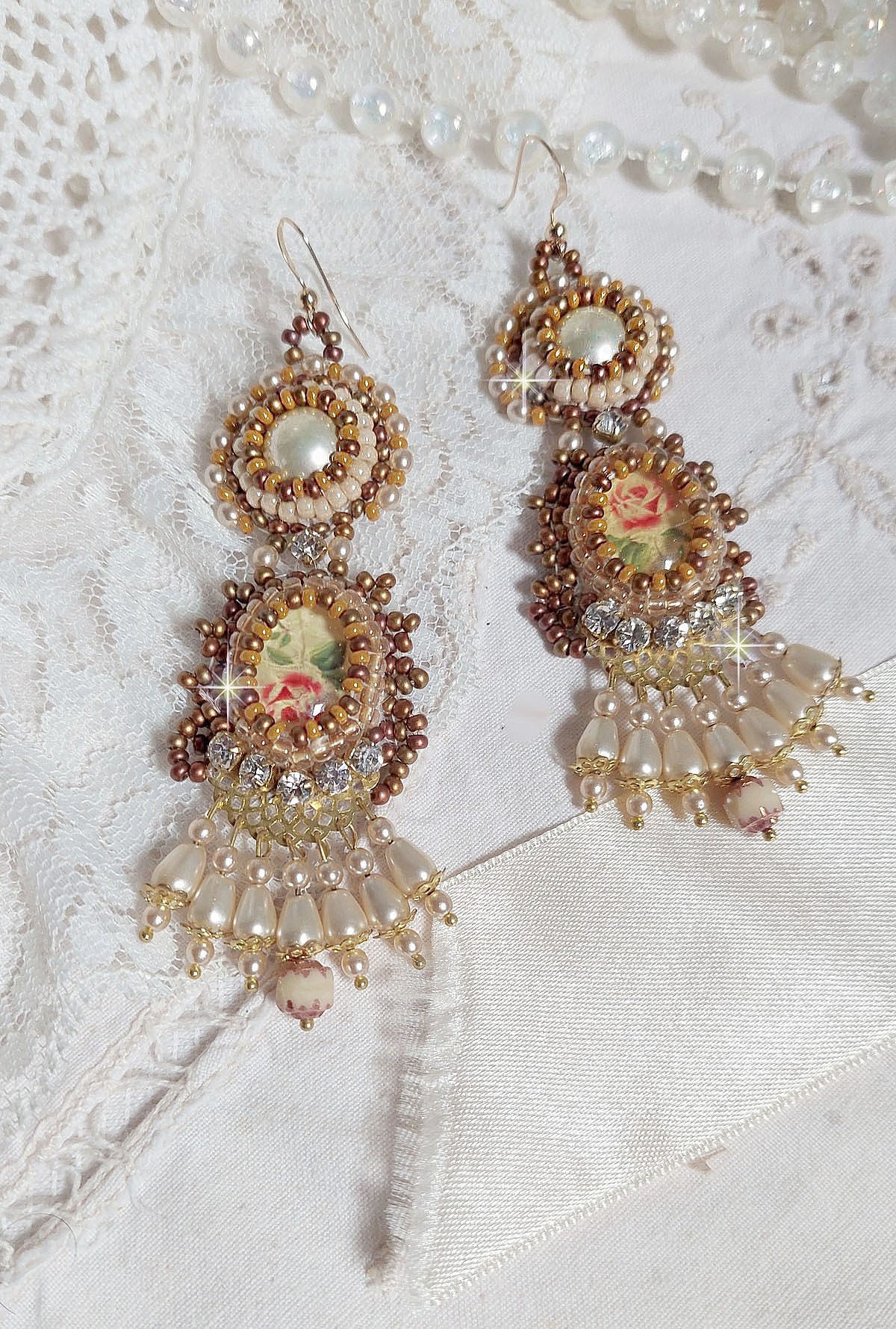 BO Reflets de Ros&eacute;e are embroidered with pearly pearls, Swarovski Crystals and 14K Gold Filled ear hooks.