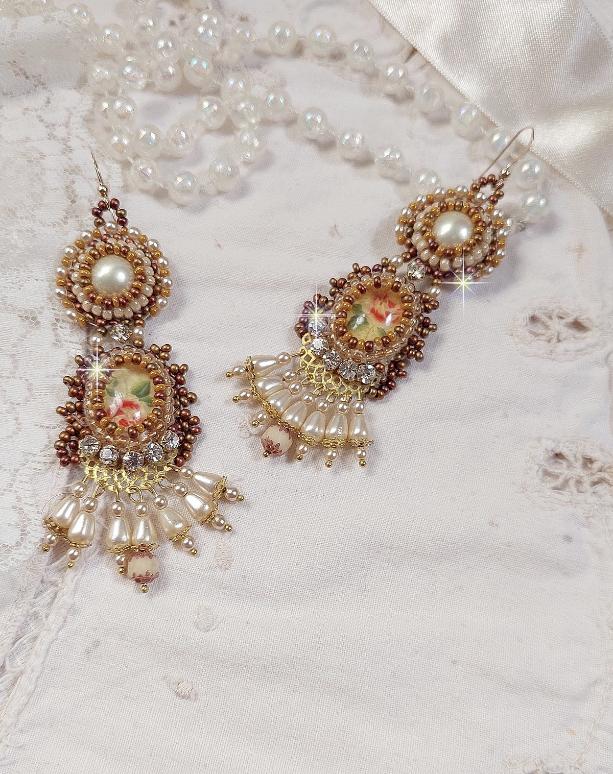BO Reflets de Ros&eacute;e are embroidered with pearly pearls, Swarovski Crystals and 14K Gold Filled ear hooks.
