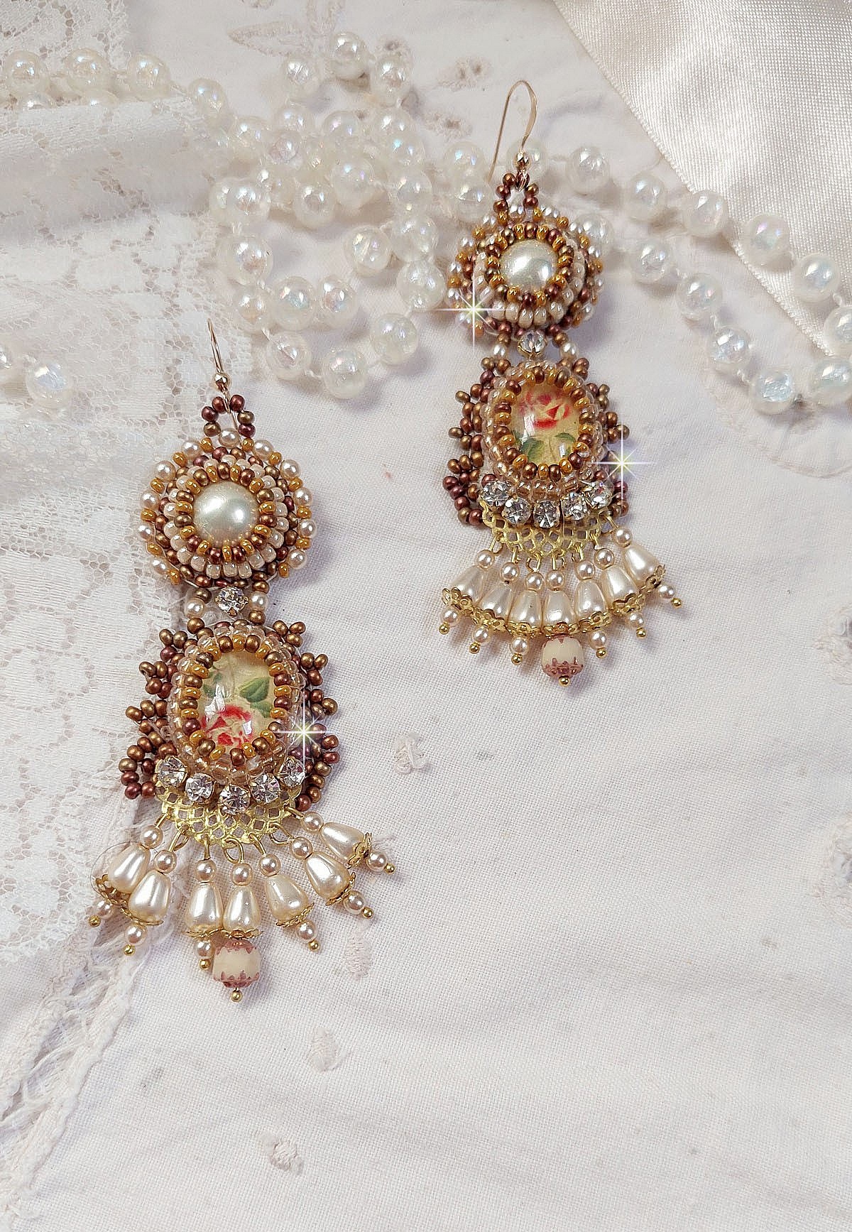 BO Reflets de Ros&eacute;e are embroidered with pearly pearls, Swarovski Crystals and 14K Gold Filled ear hooks.