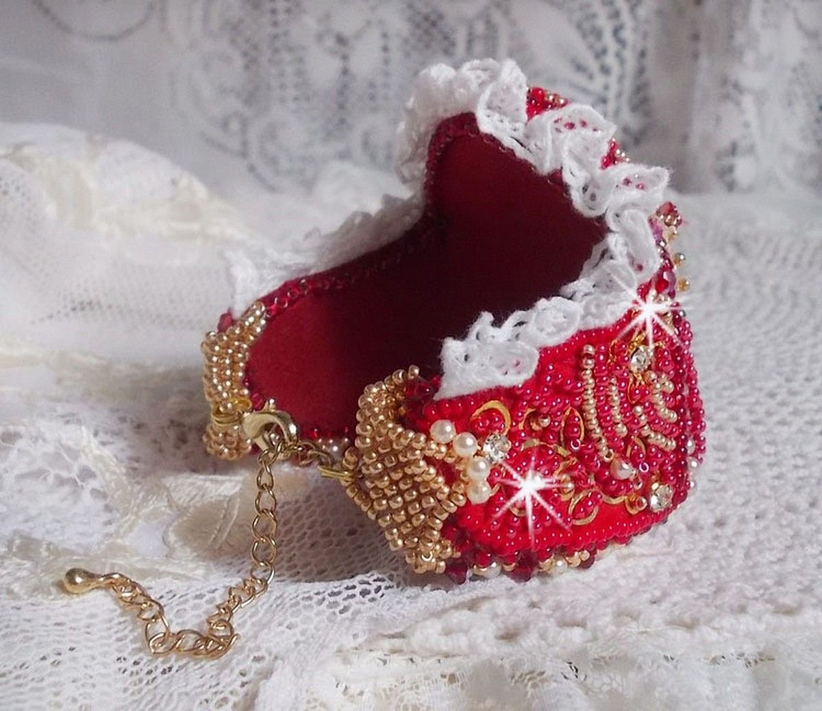 Bracelet Nous Two Haute-Couture cuff embroidered with Swarovski crystals, an oval red glass cabochon and seed beads