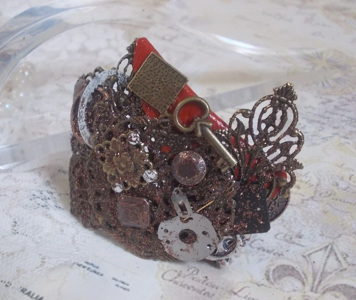 Navigating Shadow bracelet created with Cognac leather, fabric flower, accessories in Bronze, Copper, Black with charms