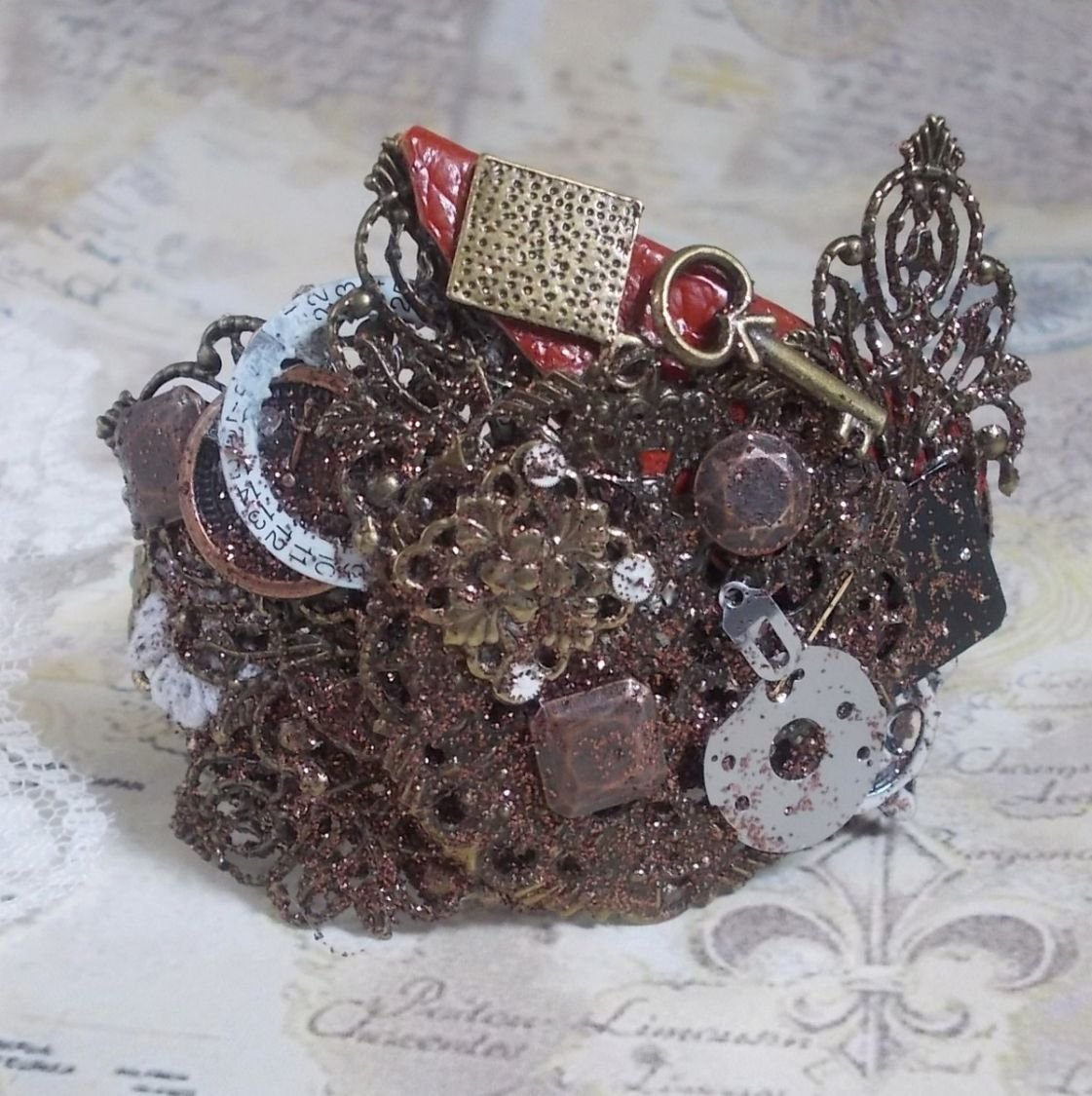 Navigating Shadow bracelet created with Cognac leather, fabric flower, accessories in Bronze, Copper, Black with charms