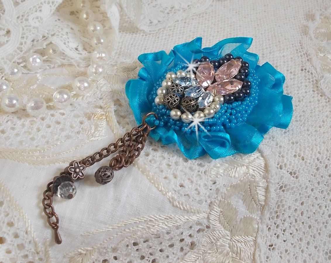 Belle Epoque Haute-Couture brooch is embroidered with Swarovski crystals, round pearls, charms, ribbon and seed beads