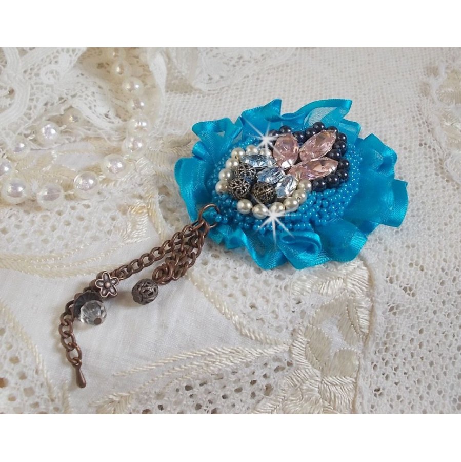 Belle Epoque Haute-Couture brooch is embroidered with Swarovski crystals, round pearls, charms, ribbon and seed beads