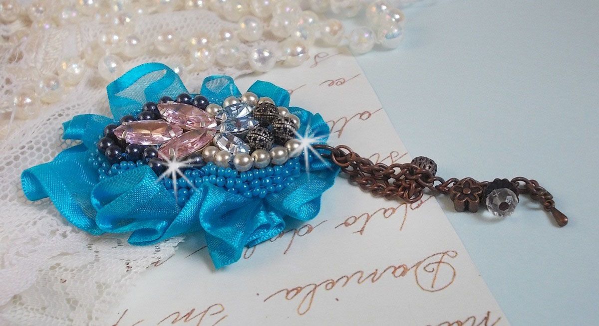 Belle Epoque Haute-Couture brooch is embroidered with Swarovski crystals, round pearls, charms, ribbon and seed beads