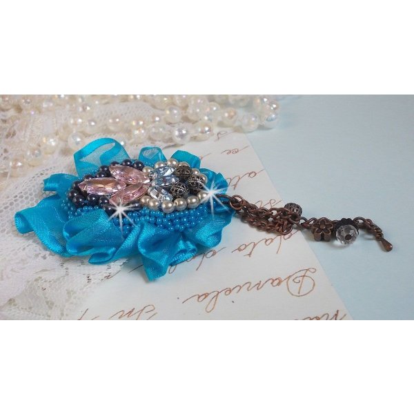 Belle Epoque Haute-Couture brooch is embroidered with Swarovski crystals, round pearls, charms, ribbon and seed beads