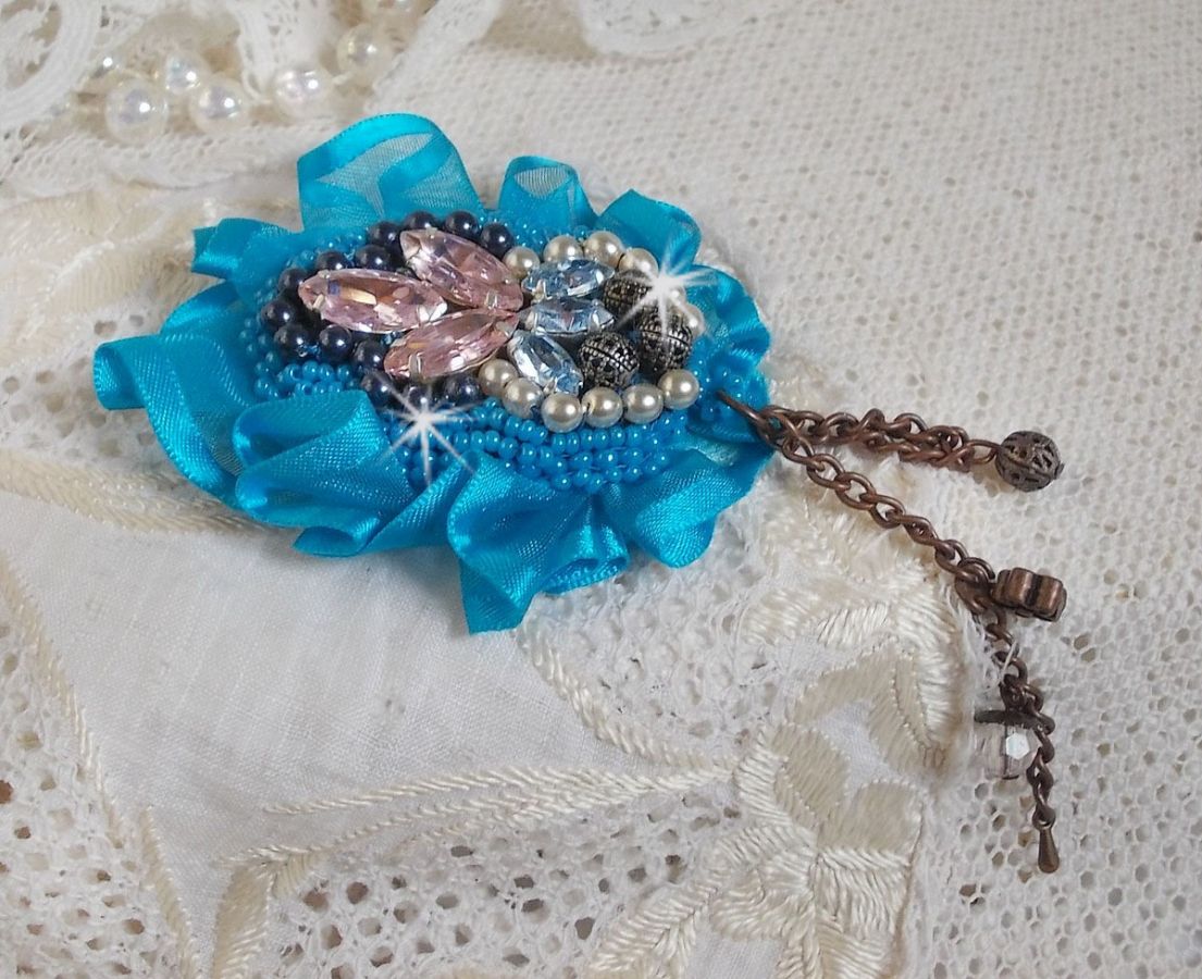 Belle Epoque Haute-Couture brooch is embroidered with Swarovski crystals, round pearls, charms, ribbon and seed beads