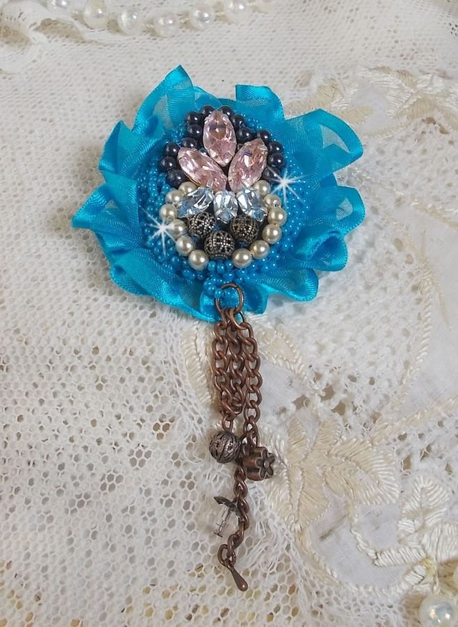 Belle Epoque Haute-Couture brooch is embroidered with Swarovski crystals, round pearls, charms, ribbon and seed beads