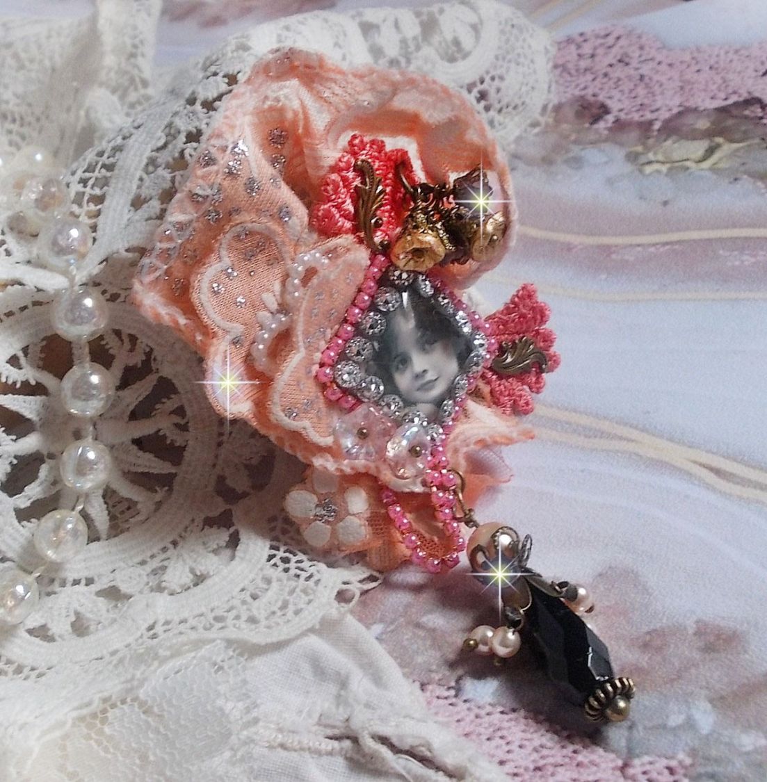 Rustic Rose brooch created with a cabochon representing a smiling girl, rhinestone and pink lace, crystals, glass beads and various accessories