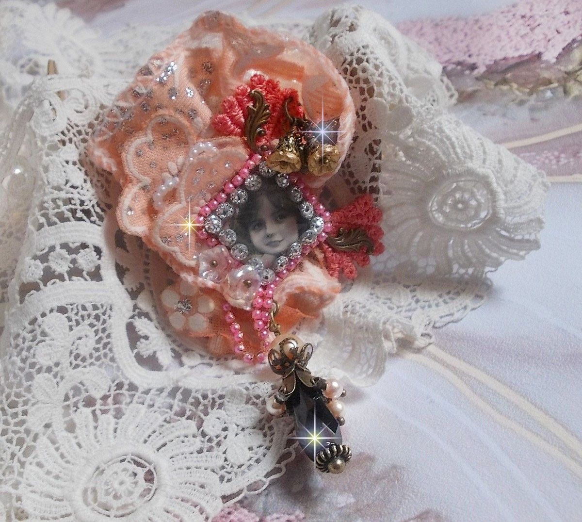 Rustic Rose brooch created with a cabochon representing a smiling girl, rhinestone and pink lace, crystals, glass beads and various accessories