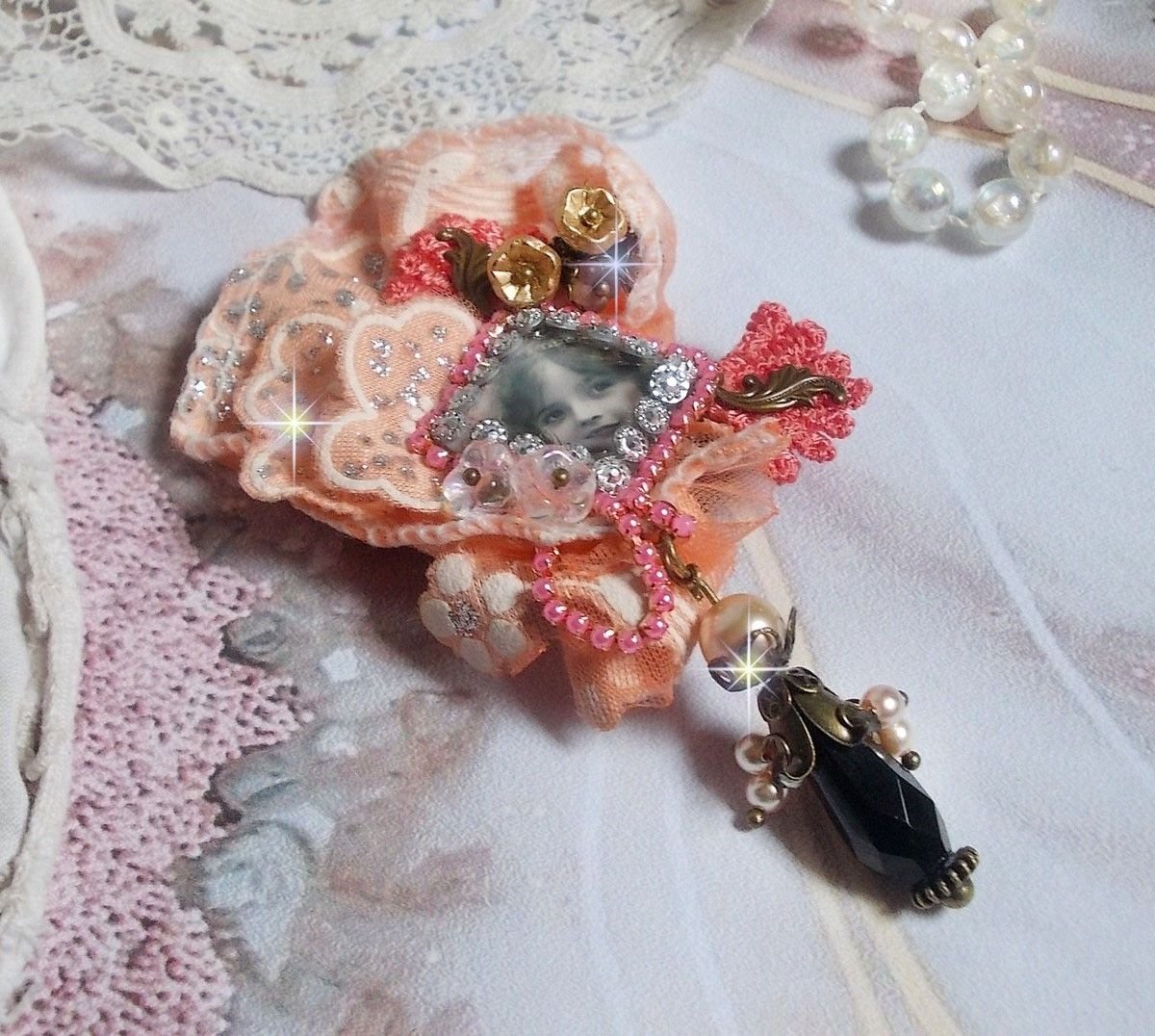 Rustic Rose brooch created with a cabochon representing a smiling girl, rhinestone and pink lace, crystals, glass beads and various accessories