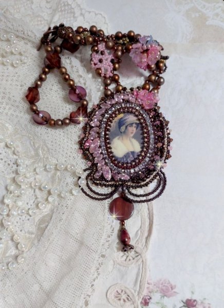 Belle Romance Haute-Couture necklace embroidered with a cabochon portrait of a woman in a hat with crystals, satin pearls, golden round pearls, mother of pearl cabochons and 