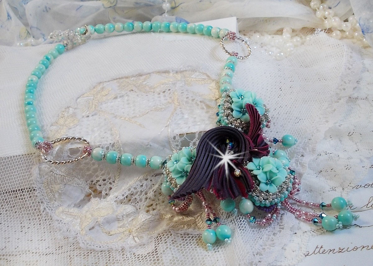 Blue Flowers Haute-Couture necklace embroidered with Swarovski crystals, a silk ribbon in Truffle/Raspberry color and seed beads