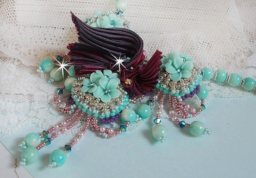Blue Flowers Haute-Couture necklace embroidered with Swarovski crystals, a silk ribbon in Truffle/Raspberry color and seed beads