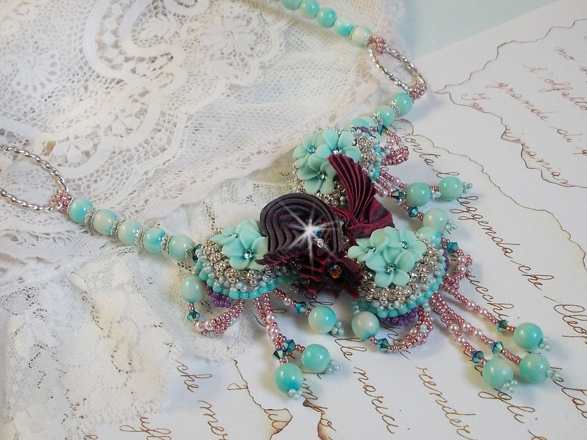 Blue Flowers Haute-Couture necklace embroidered with Swarovski crystals, a silk ribbon in Truffle/Raspberry color and seed beads