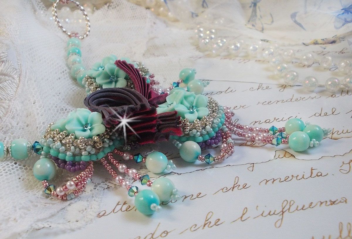 Blue Flowers Haute-Couture necklace embroidered with Swarovski crystals, a silk ribbon in Truffle/Raspberry color and seed beads