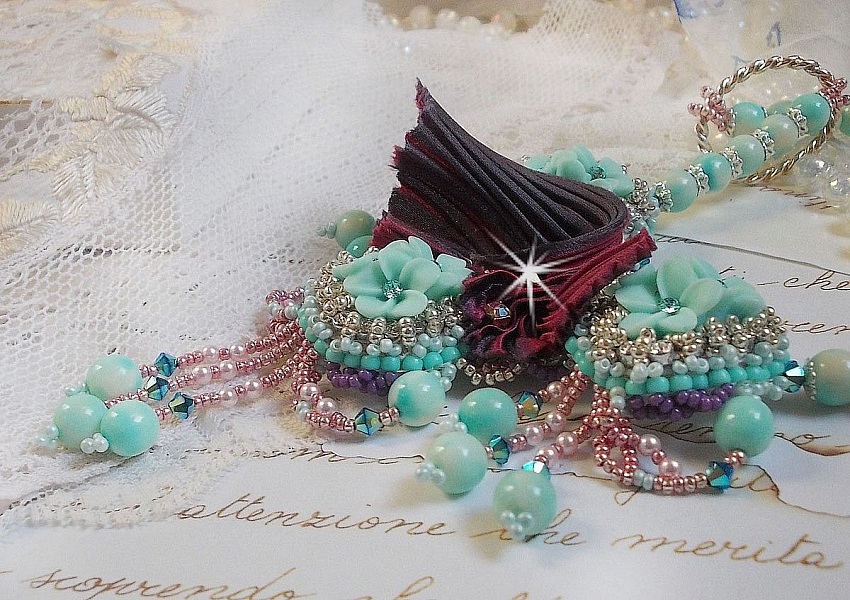 Blue Flowers Haute-Couture necklace embroidered with Swarovski crystals, a silk ribbon in Truffle/Raspberry color and seed beads