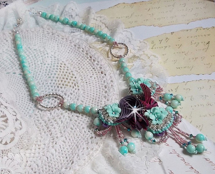Blue Flowers Haute-Couture necklace embroidered with Swarovski crystals, a silk ribbon in Truffle/Raspberry color and seed beads