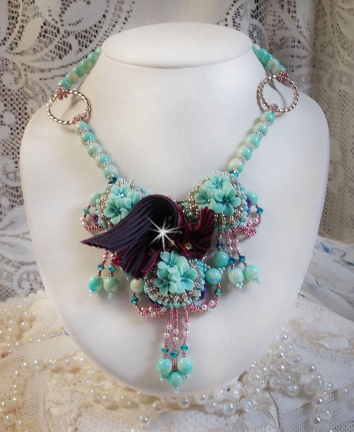 Blue Flowers Haute-Couture necklace embroidered with Swarovski crystals, a silk ribbon in Truffle/Raspberry color and seed beads