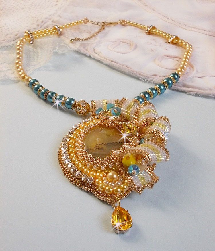 Haute-Couture Sunflower Gold pendant embroidered with 24 karat gold-plated seed beads, a Madagascar opal and Swarovski crystals.