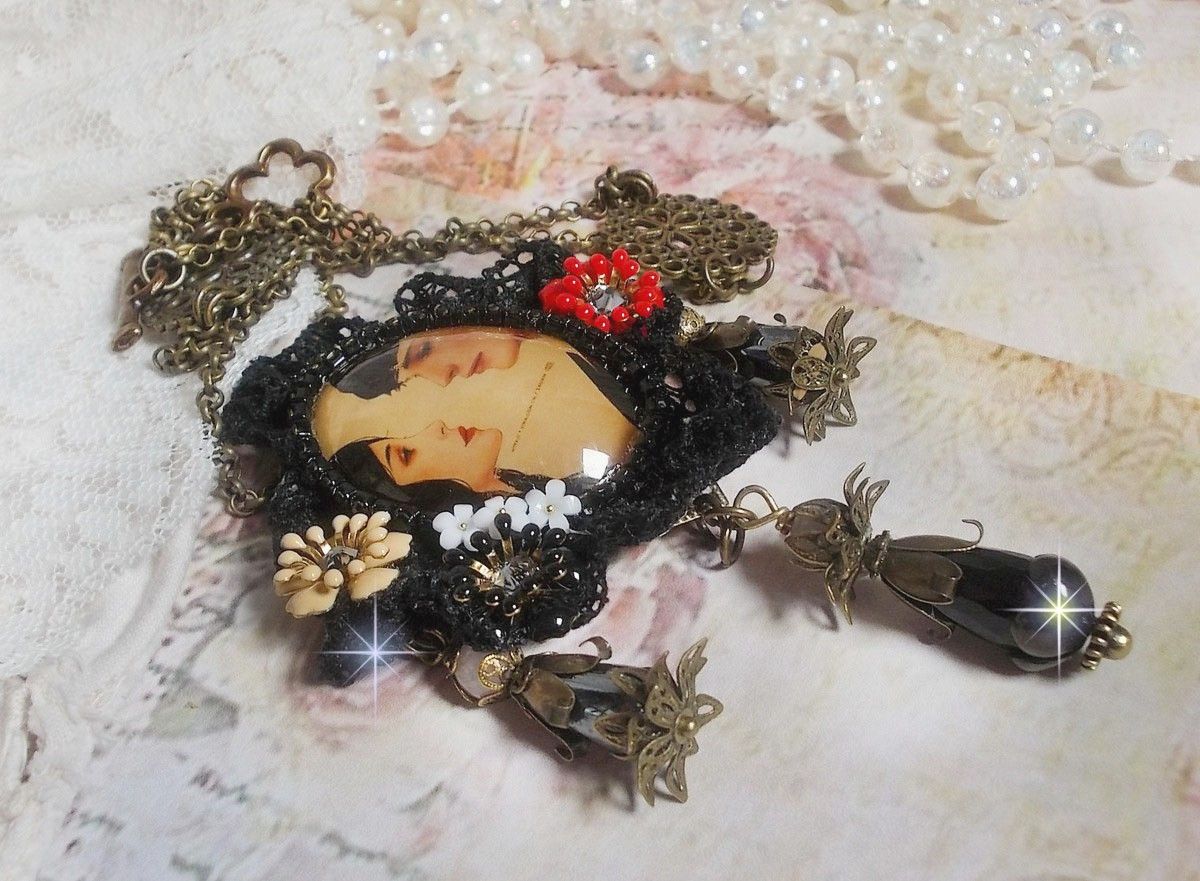 Love Romance necklace created with crystals, an oval cabochon representing two women, Quartz, Hematite, gold plated beads and other accessories