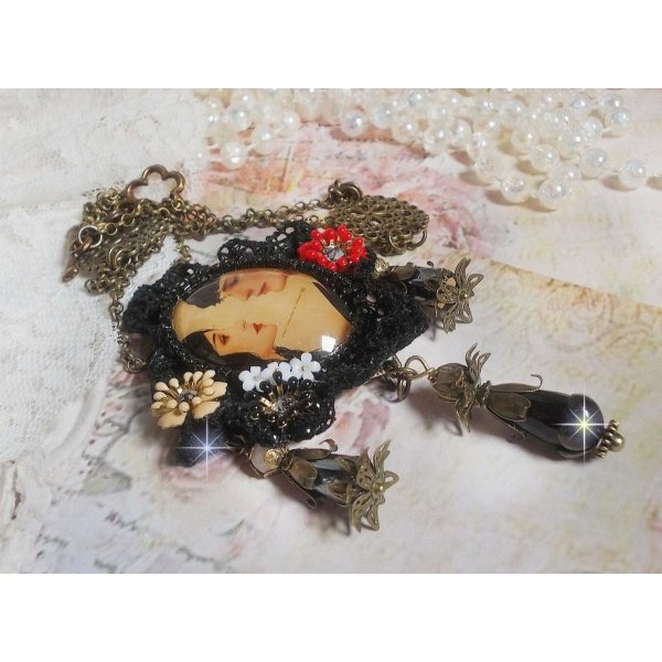 Love Romance necklace created with crystals, an oval cabochon representing two women, Quartz, Hematite, gold plated beads and other accessories