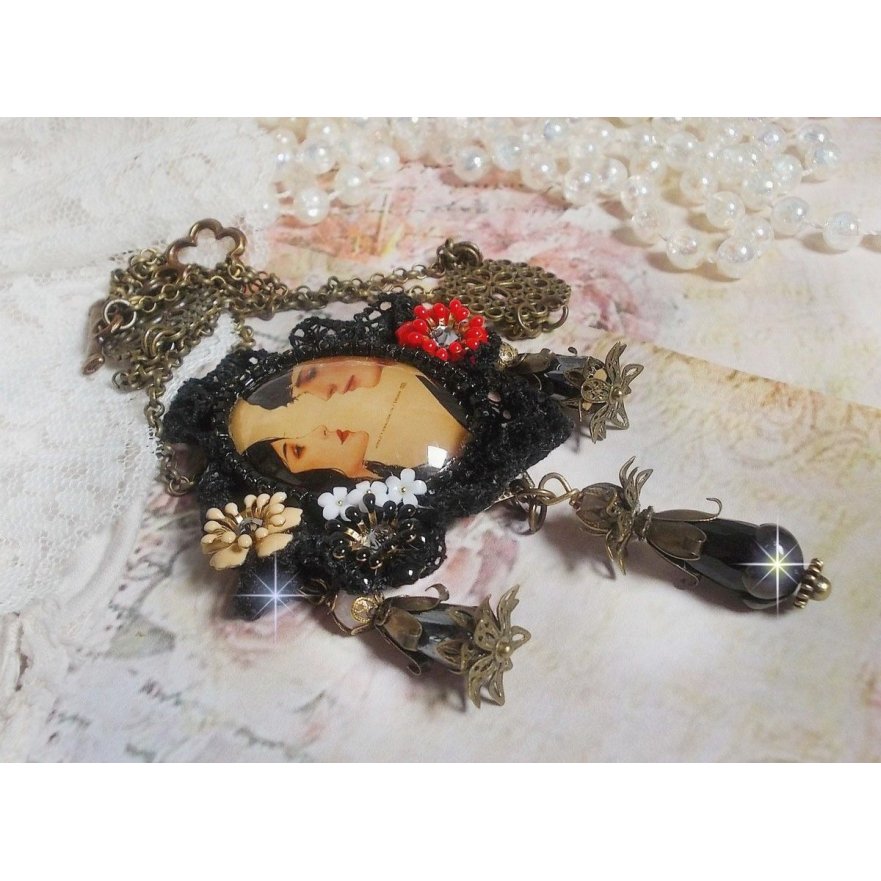 Love Romance necklace created with crystals, an oval cabochon representing two women, Quartz, Hematite, gold plated beads and other accessories