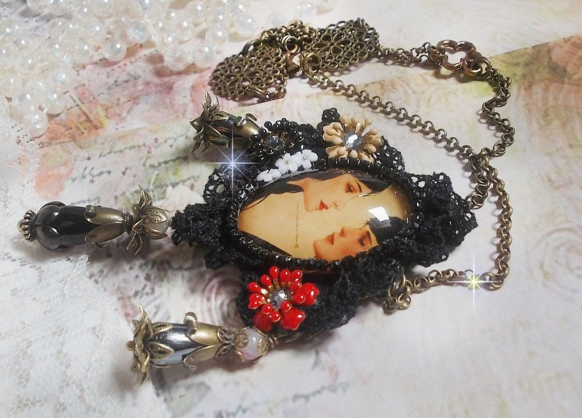 Love Romance necklace created with crystals, an oval cabochon representing two women, Quartz, Hematite, gold plated beads and other accessories