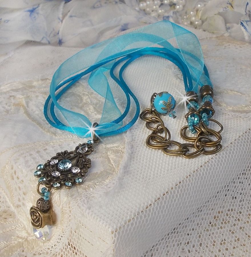 Lady in Blue pendant necklace mounted with Swarovski crystals, flower spacers, foliage cups and ribbons