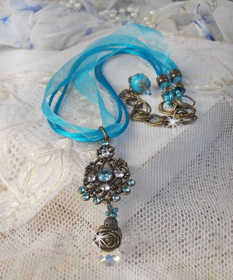 Lady in Blue pendant necklace mounted with Swarovski crystals, flower spacers, foliage cups and ribbons