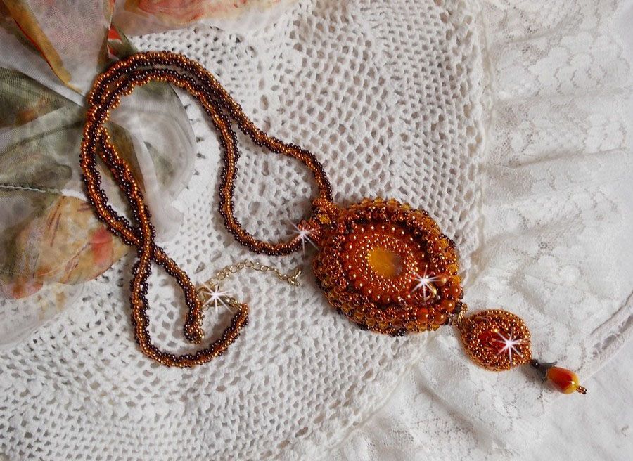 Lady in Orange pendant necklace is embroidered with Swarovski crystals, Miyuki seed beads and magic beads.