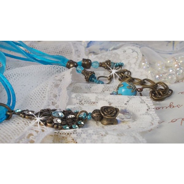 Lady in Blue pendant necklace mounted with Swarovski crystals, flower spacers, foliage cups and ribbons