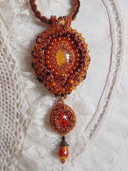 Lady in Orange pendant necklace is embroidered with Swarovski crystals, Miyuki seed beads and magic beads.