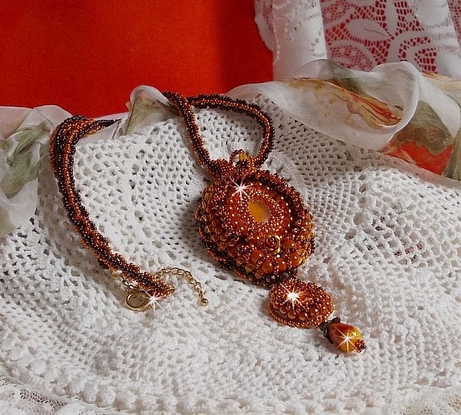 Lady in Orange pendant necklace is embroidered with Swarovski crystals, Miyuki seed beads and magic beads.