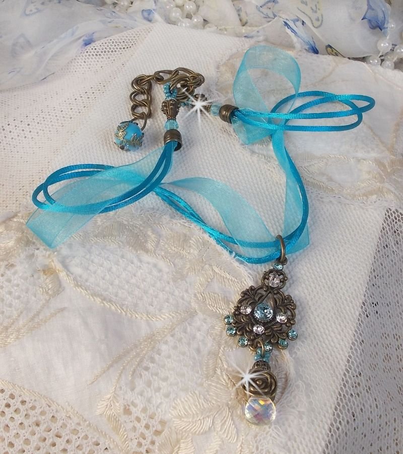 Lady in Blue pendant necklace mounted with Swarovski crystals, flower spacers, foliage cups and ribbons