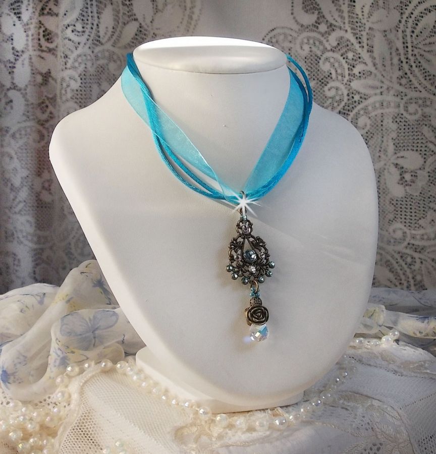 Lady in Blue pendant necklace mounted with Swarovski crystals, flower spacers, foliage cups and ribbons