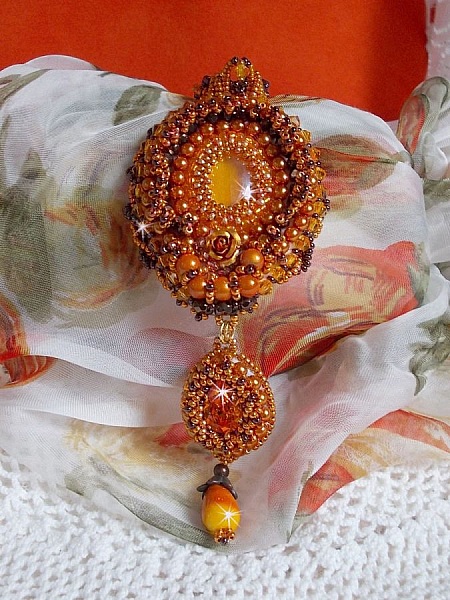 Lady in Orange pendant necklace is embroidered with Swarovski crystals, Miyuki seed beads and magic beads.