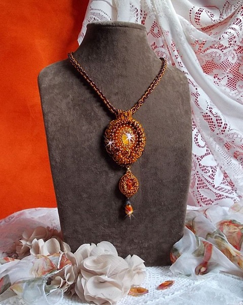 Lady in Orange pendant necklace is embroidered with Swarovski crystals, Miyuki seed beads and magic beads.