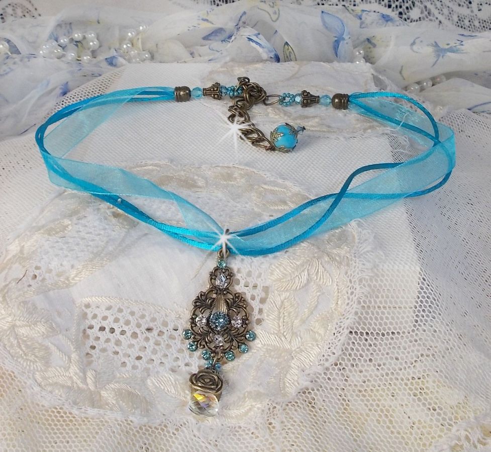 Lady in Blue pendant necklace mounted with Swarovski crystals, flower spacers, foliage cups and ribbons