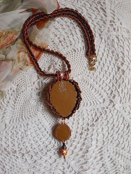 Lady in Orange pendant necklace is embroidered with Swarovski crystals, Miyuki seed beads and magic beads.