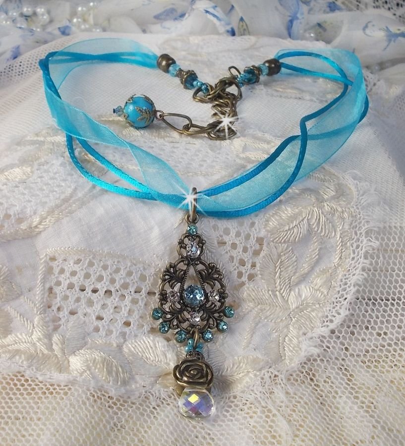 Lady in Blue pendant necklace mounted with Swarovski crystals, flower spacers, foliage cups and ribbons