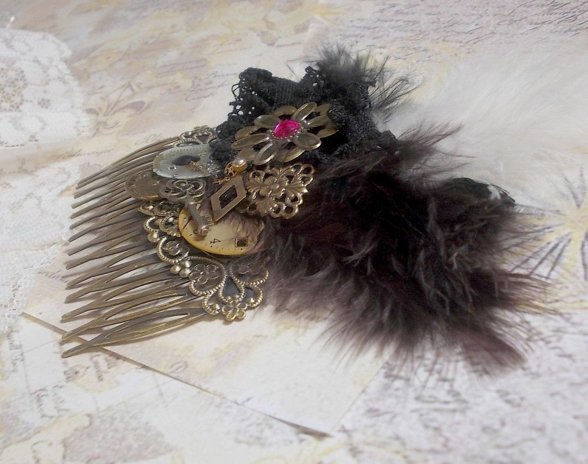 Curiosity Time hair comb created with black lace, various accessories, charms of gold, silver, bronze colors with black, brown and white feathers