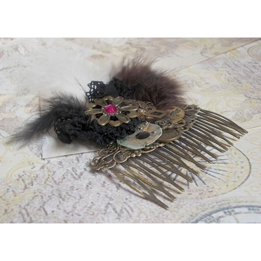 Curiosity Time hair comb created with black lace, various accessories, charms of gold, silver, bronze colors with black, brown and white feathers